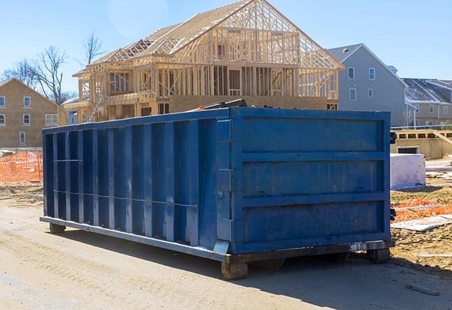 a waste management company picking up trash from a residential dumpster